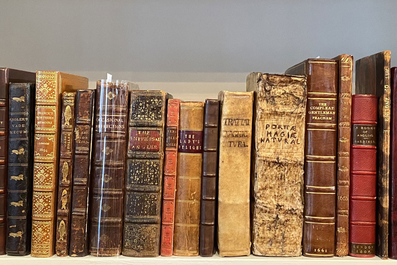 A row of books from the Thacher collection on a bookshelf.